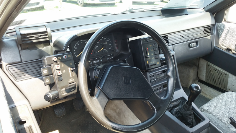 Interior of the above Isuzu Impulse. So many buttons. So much better than touch-screens.